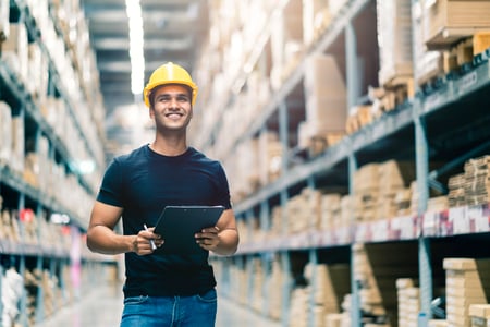 smart-indian-engineer-man-wearing-safety-helmet-doing-stock-tick-check-cardboard-stock-product-management-factory-warehouse-background