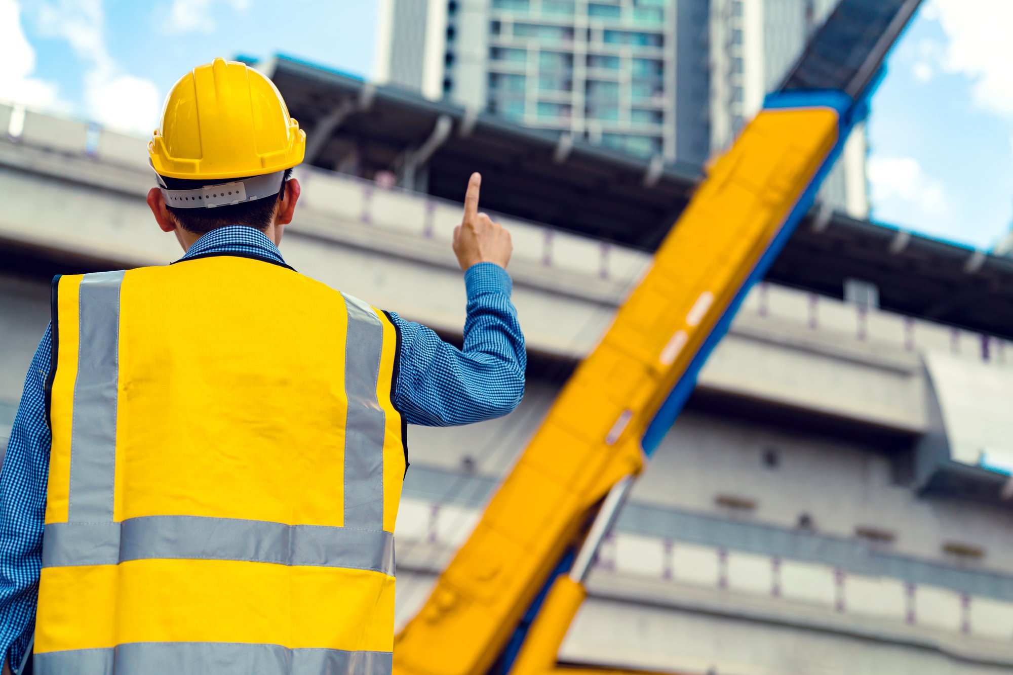 smart-asian-engineer-manager-with-safety-uniform-checking-site-construction-with-steel-concrete-sturcture-background