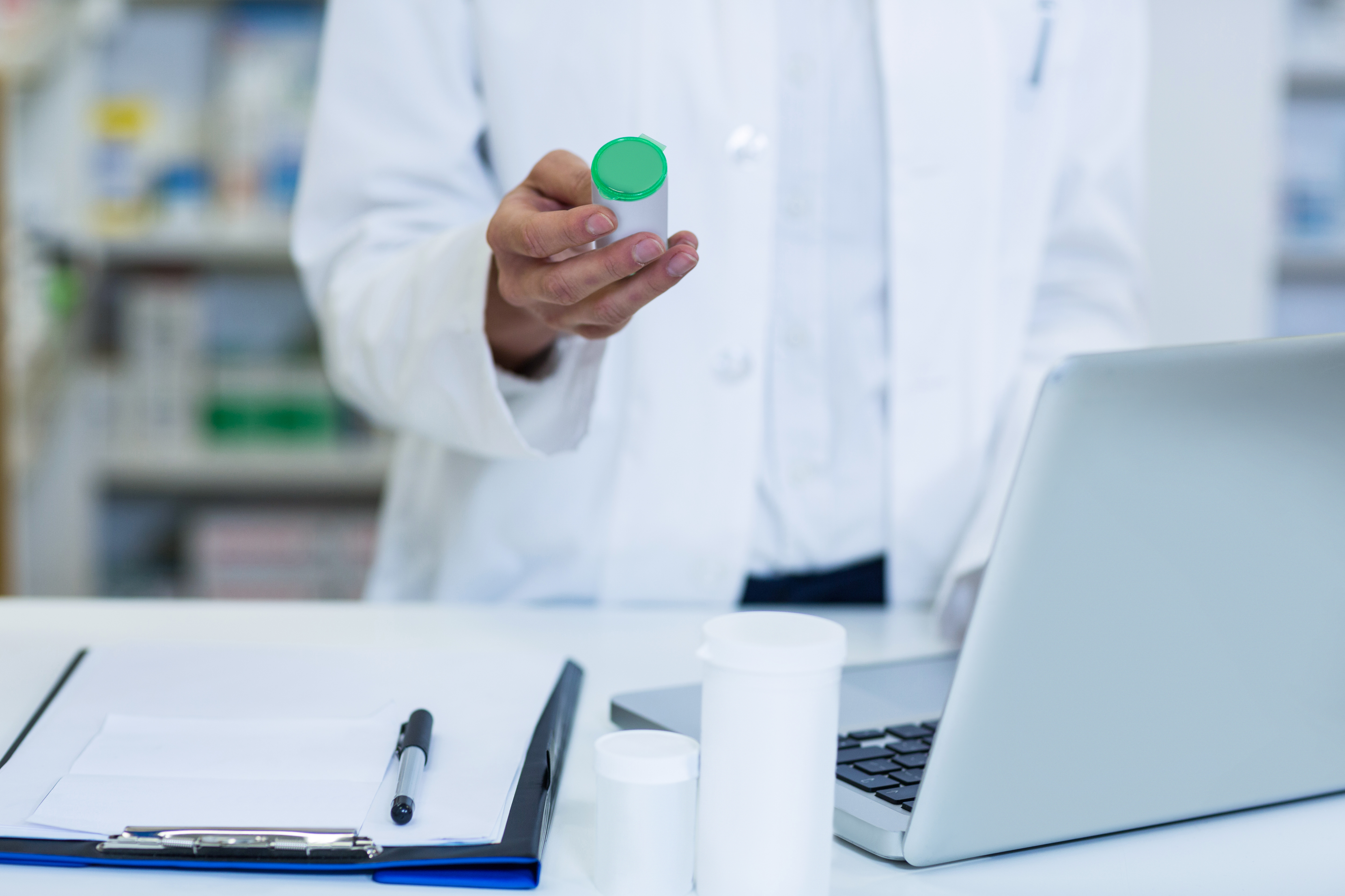 Pharmacist checks medicine on GMP certification requirements 