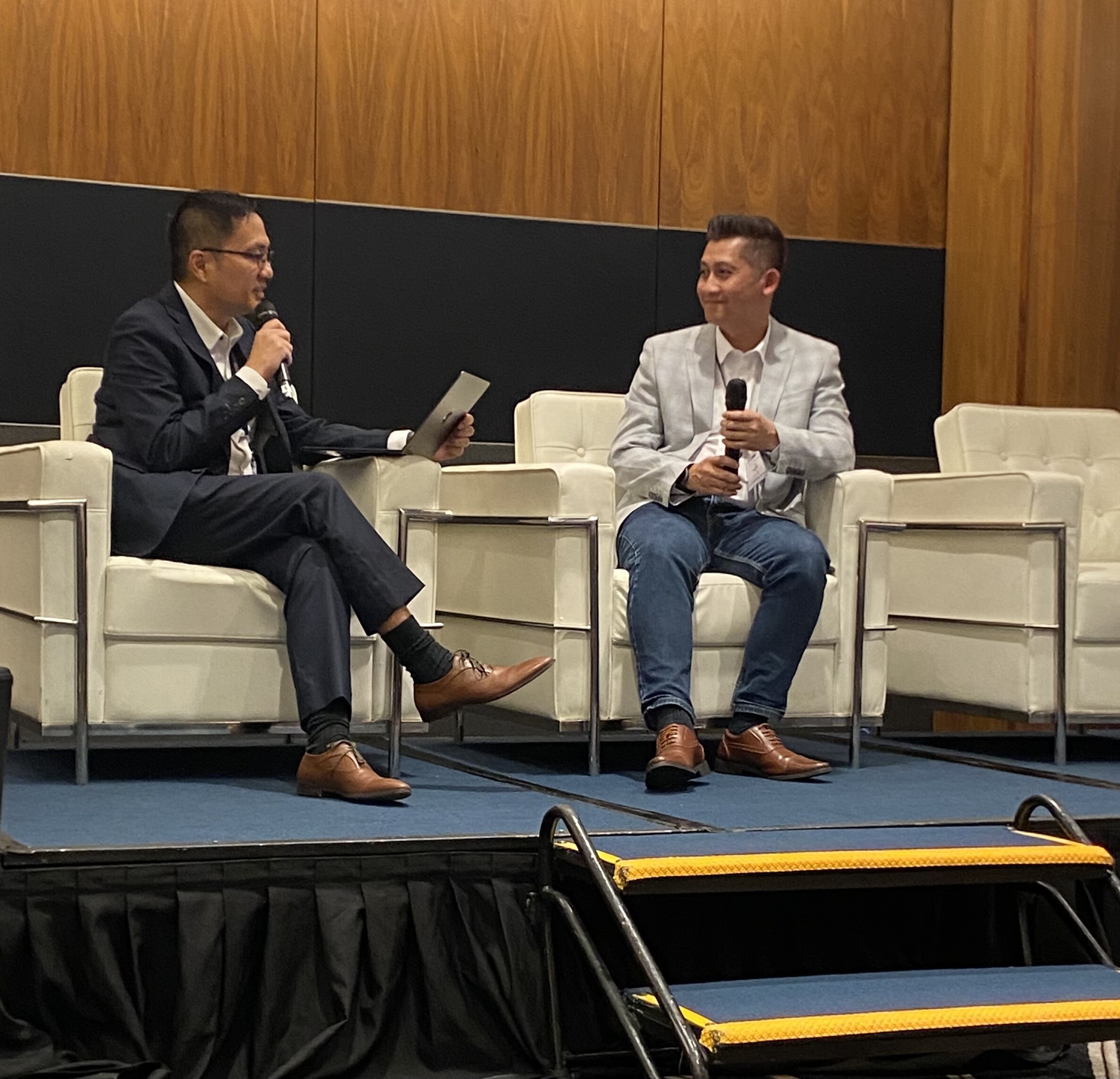 Victor Wong and Muhd-Affan MOHD-NOOR from TotalEnergies on stage at the Bizzmine QHSE  Summit in Singapore